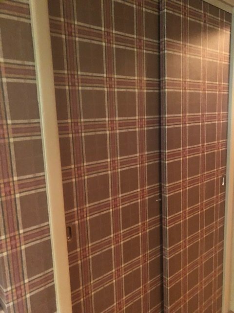 Plaid wallpaper on closet door